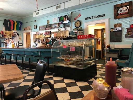 Inside Orsak's Cafe — counter seating, checkered floor, and pie case by the register